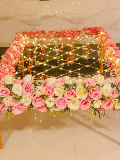 A beautiful Phoolon ki Chadar made with pink and white flowers and illuminated with fairy lights. This rental adds a romantic and dreamy touch to the bride's walk down the aisle.