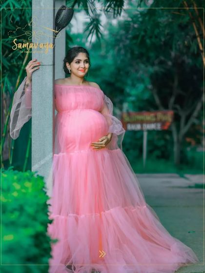 A beautiful portrait showing the full elegance of the pink gown in a green, natural setting. This is a perfect look for a dreamy garden maternity shoot.