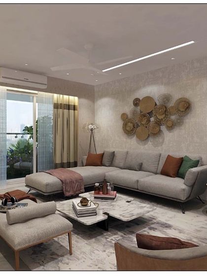 A contemporary living room where a large grey sectional sofa provides ample seating. The space is accented with a striking metal wall sculpture and pops of color in the cushions, creating a dynamic yet harmonious look.