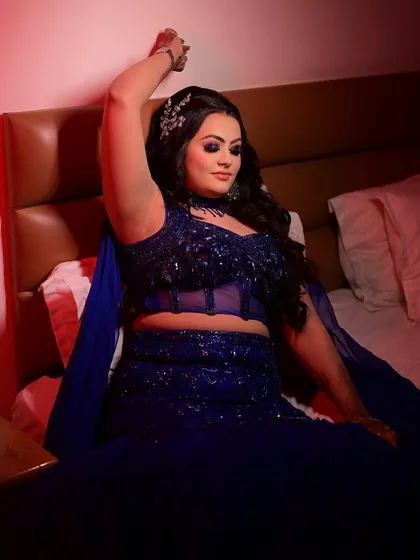 A full-length shot showing the stunning blue gown and the complete makeup and hair look. This is a perfect example of a modern, glamorous style for a sangeet or cocktail night.