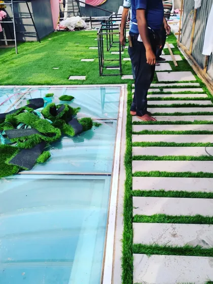 This project involved laying a grass path next to a glass-covered opening on the roof.
