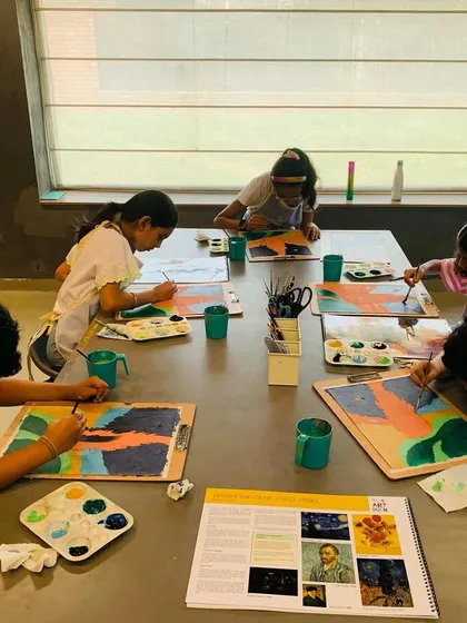 A full view of the class working on their Van Gogh landscapes, each interpreting the style in their own way.