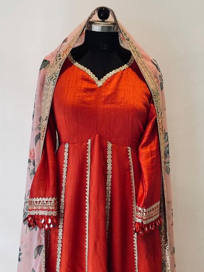 My 'toasted orange' Anarkali paired with a beautiful floral organza dupatta. The combination of the solid, rich color with the printed, airy fabric creates a balanced and sophisticated festive look.