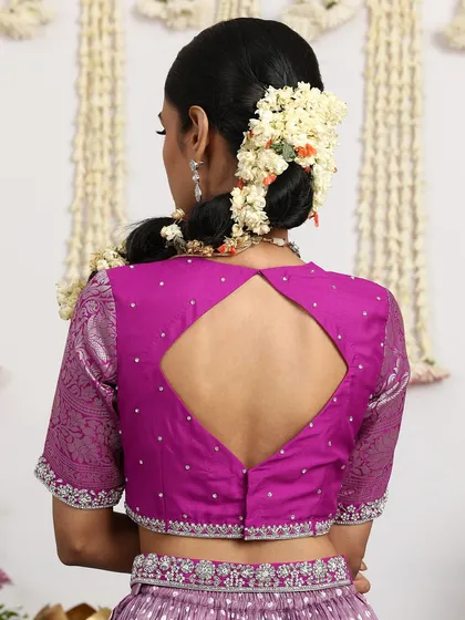 The back of the magenta blouse reveals a modern diamond-shaped keyhole design.