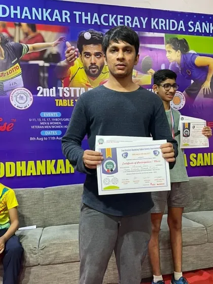 One of our men's quarter-finalists, Mukul Jain, holding his certificate of merit. We support players across all age groups, from juniors to veterans.