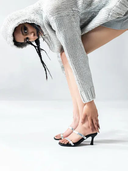 This look for Two Fifty Seven combined a casual silver hoodie with elegant heels, creating a cool, high-low fashion statement.