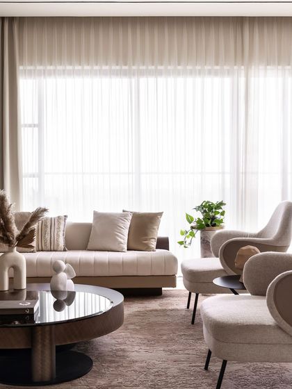 Another view of the living area, showcasing the balance between the plush furniture and the strong vertical lines of the wood paneling.