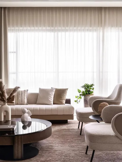 Another view of the living area, showcasing the balance between the plush furniture and the strong vertical lines of the wood paneling.