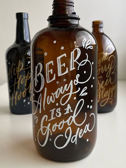 "Beer always is a good idea." A beer growler hand-lettered with white paint, part of a larger set for party decor. This showcases a more playful, casual style of lettering.