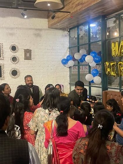 A candid moment from a birthday party, with family and friends gathered to watch the cake cutting. We help manage the event so you can be present in the moment.
