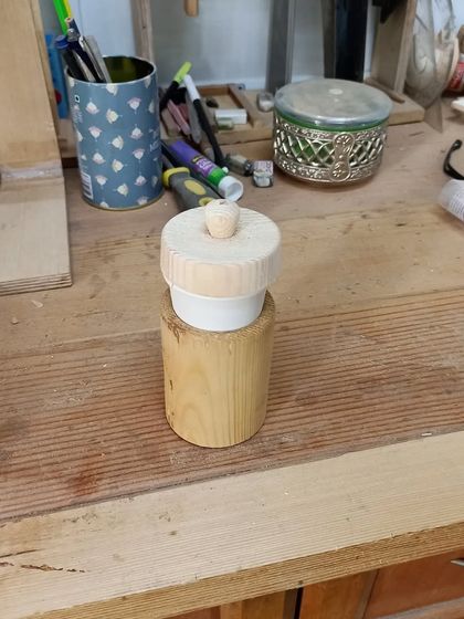 The finished wooden cup holder with its lid. This was turned from a single piece of wood, with the inside hollowed out and a lid fitted for a snug closure.
