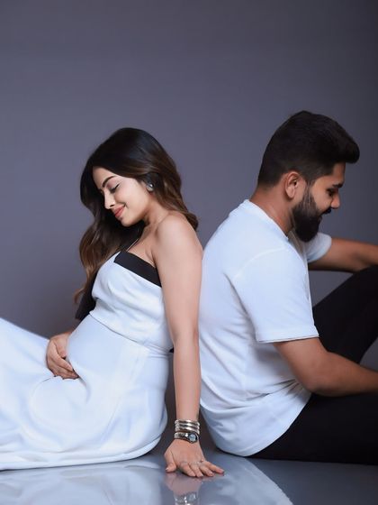 A quiet, reflective pose. Sitting back-to-back, this shot symbolizes their individual journeys and the shared path they are on together, creating a simple yet meaningful portrait.