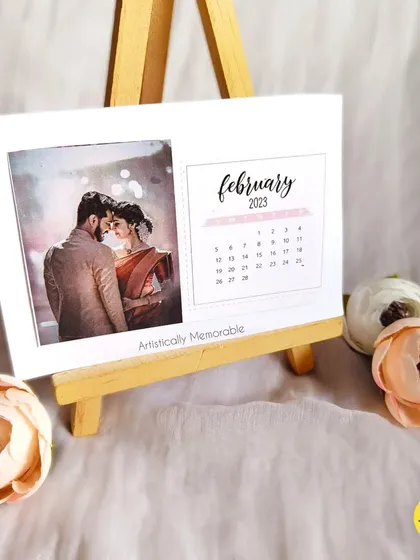 A close-up of the February 2023 calendar card, highlighting the elegant script and photo placement.