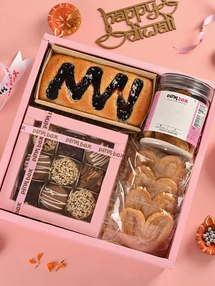 Our "Anand" hamper is designed for pure indulgence. It features a Blueberry Marble Cake, assorted truffle balls, savory Garlic Toasties, and a pack of French Hearts.