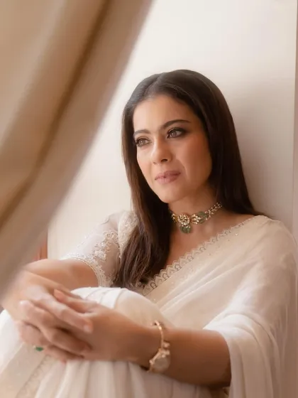 A close-up on the face, showing the flawless makeup and the beautiful craftsmanship of the jewelry.