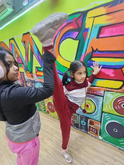 Teamwork makes the dream work. In our kids' classes, we encourage students to support each other as they work on their flexibility and master new skills.