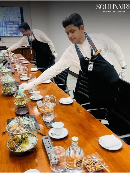 Our service team meticulously setting up for a corporate boardroom meeting. We bring the same level of precision and elegance to intimate corporate gatherings as we do to large-scale events.