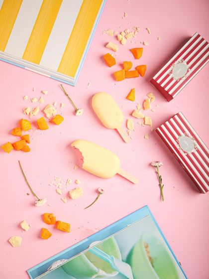 Another flat-lay of our mango ice cream bars, showcasing their vibrant colour and fun packaging.