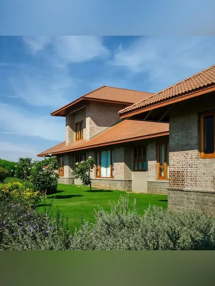 The simple brick architecture of this home is beautifully complemented by the soft, natural forms of the garden. We designed the landscape with rolling lawns and informal clusters of plants for a relaxed, countryside feel.