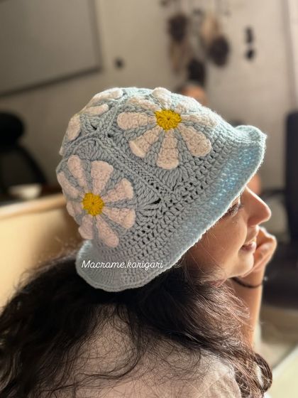 Another look at the craftsmanship of our daisy bucket hat. The stitch work is airy, making it a great choice for warmer weather while still providing shade.