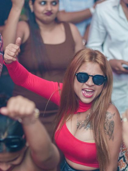 A guest with a cool vibe and sunglasses on, enjoying the music.