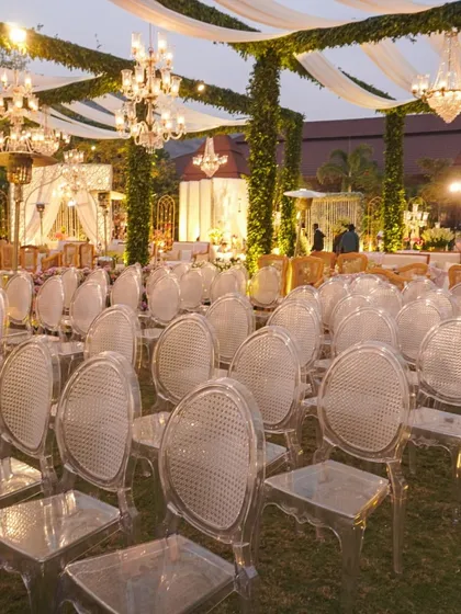 We love mixing modern eclecticism with traditional charm. Here, we paired modern ghost chairs with grand 'Umrao Jaan' style chandeliers and pillars wrapped in greenery, proving that opposites really do attract.