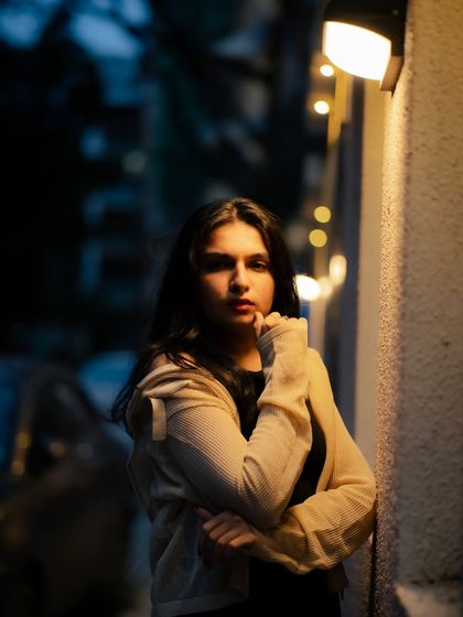 This portrait has a classic, cinematic feel. The pose and lighting work together to create a story within the image.