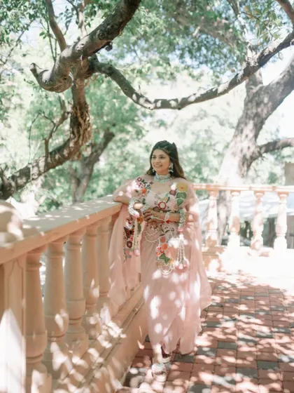The bride looks ethereal in the soft sunlight, her braided hairstyle perfectly matching the dreamy, romantic setting.