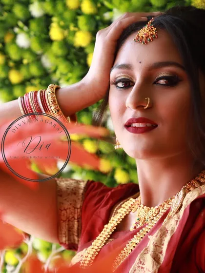 Fearlessly elegant. This photoshoot look features a deep red saree, traditional gold jewellery, and a bold red lip with dramatic winged eyeliner for a powerful and classic image.