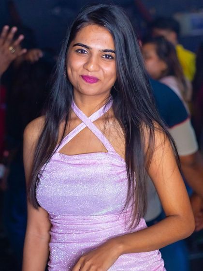 A guest in a sparkly pink dress.