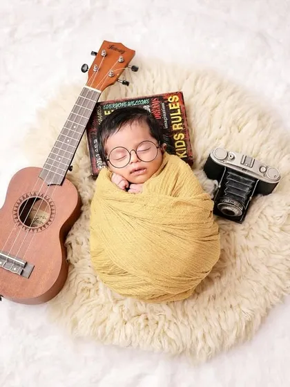 For the cool and creative family, this newborn setup with a tiny ukulele and vintage camera is perfect. It’s a fun way to incorporate your own hobbies and personality into the shoot.