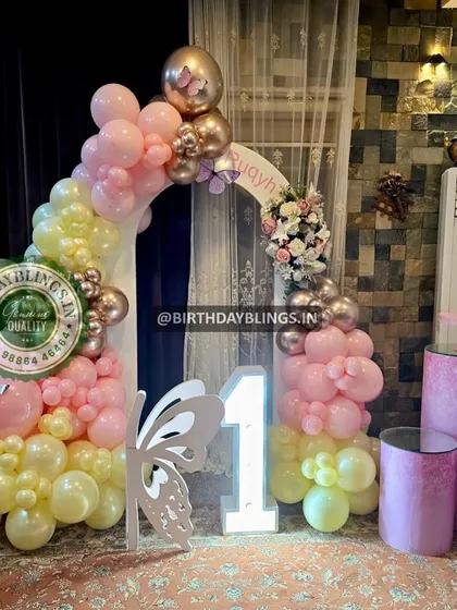 The full view of the butterfly-themed setup, including themed plinths for the cake and desserts.