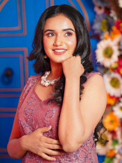 A thoughtful pose. The airbrush makeup provides a smooth canvas, and the soft pink tones on the eyes and cheeks add a touch of color.