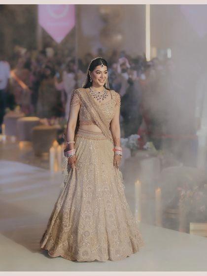 Shreya's grand bridal entry. The smoky atmosphere and the full view of her magnificent lehenga create a dramatic and unforgettable moment, capturing the anticipation and excitement of her arrival.