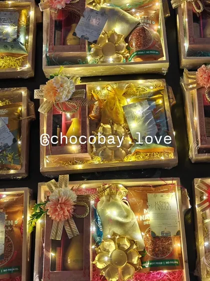 The same wooden gift hampers illuminated with fairy lights, adding a festive sparkle that makes the gift even more special.