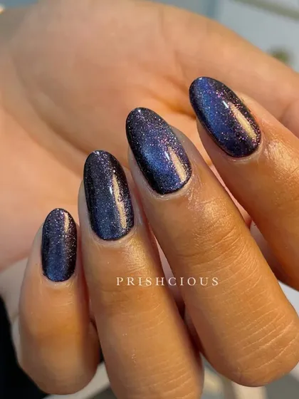 This client is carrying a whole galaxy on her nails. This is a 9D cat eye polish that has multiple colors and layers of glitter for a deep space effect.