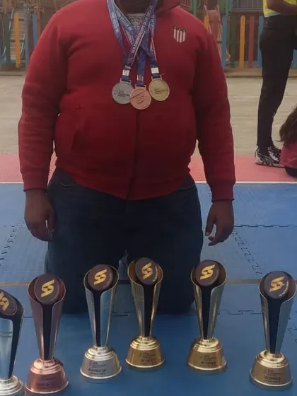 A display of dedication. This player's collection of medals and trophies from the SFA championship shows his individual contribution to our team's success.