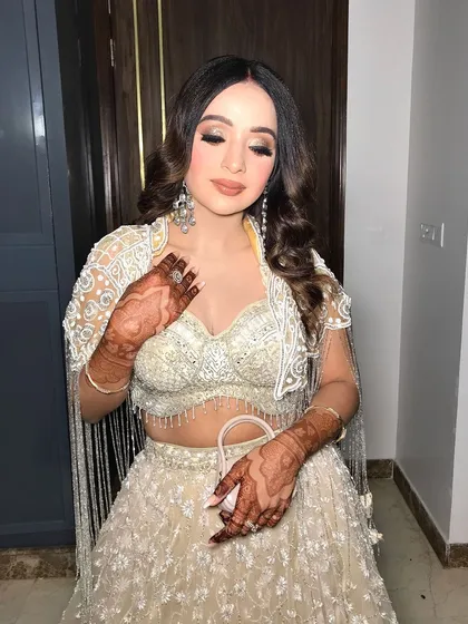 This image captures the intricate details of the blouse and the beautiful henna design.