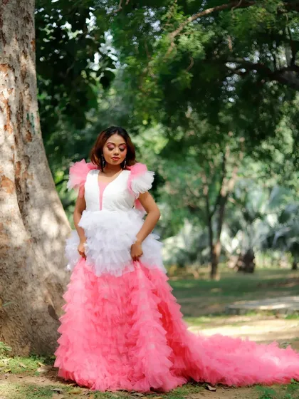 A full-length photo showing the complete editorial look. The makeup, hair, and dramatic dress come together to create a stunning, high-fashion image in a natural outdoor setting.