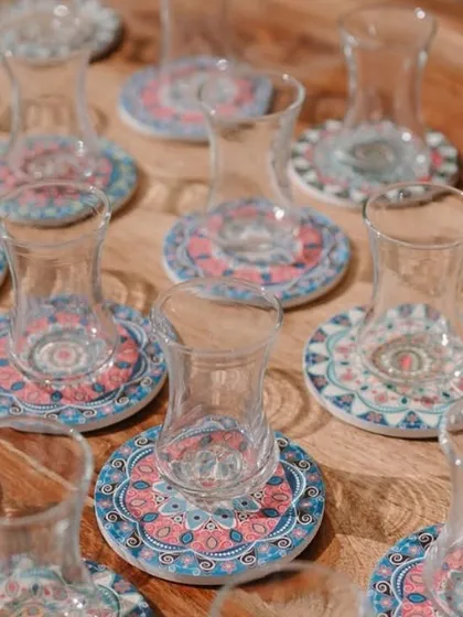 Turkish tea glasses ready for guests. The intricate coasters and elegant glassware were part of a cohesive and immersive themed event.