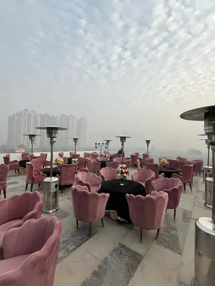 A panoramic view of the rooftop party setup, with the city skyline in the background, demonstrating our ability to transform any space.