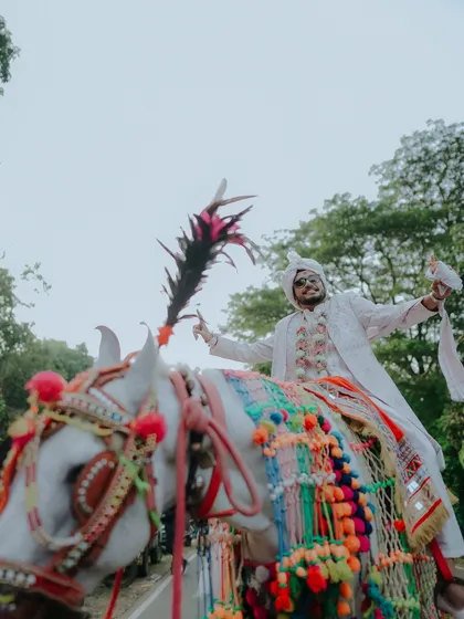 The grand entrance. A Baraat is more than a procession; it's a celebration of the journey to come. I focus on capturing the groom's joy and the vibrant energy of his family and friends in this unforgettable moment.