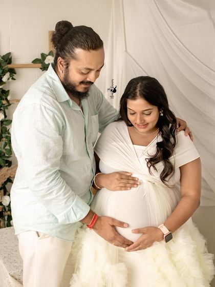 The couple shares a quiet moment, both connecting with the baby. I guide my clients into poses that feel natural and highlight their bond.