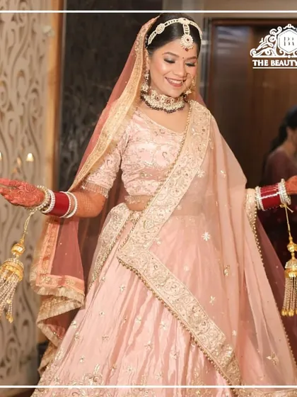 I love working with pastel palettes for a modern bridal look. This bride is glowing in her soft pink lehenga, and I created a dewy, fresh makeup look with rosy tones to enhance her natural beauty. It's a perfect example of contemporary bridal elegance.