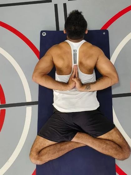 An overhead view of Paschima Namaskarasana, or Reverse Prayer Pose, while seated. This asana is a fantastic shoulder opener and helps to improve posture by drawing the shoulder blades together.