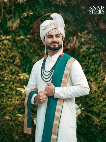 A handsome groom in his traditional attire, ready for his wedding. Our groom portraits are stylish and capture his unique personality.