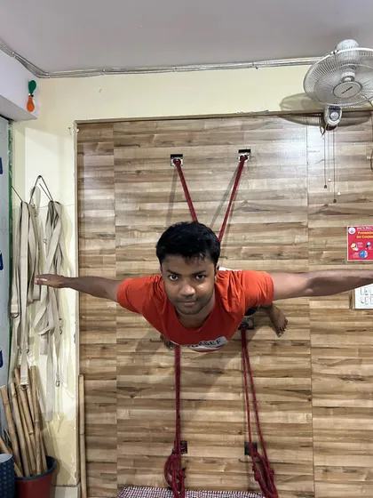 A front view of the rope-assisted horizontal pose. Notice the open chest and the straight line of the body. This is not just a physical challenge; it builds mental focus and endurance as you learn to hold the posture with stability and calm breath.