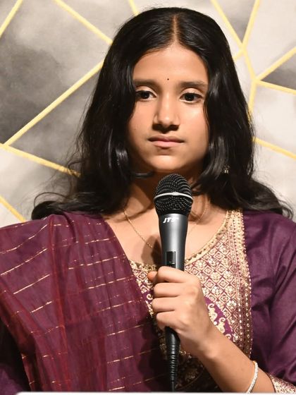 A young student delivering a focused performance. We train students from a young age to be comfortable and poised on stage.