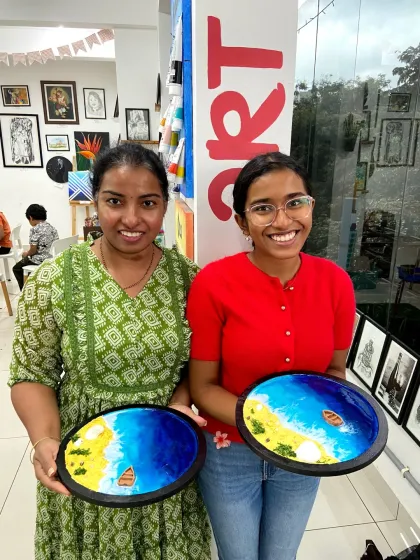 A mother and daughter duo with their finished resin beach art. It's a wonderful activity for families to enjoy together.