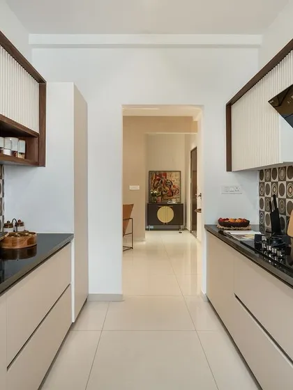This galley kitchen is designed for efficiency and style. I used geometric patterned tiles for the backsplash to add visual interest, contrasted with sleek black countertops and minimalist white cabinetry. The design ensures a functional workflow in a compact space.